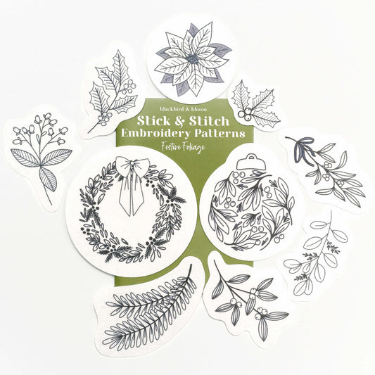 Embroidery Pattern Stickers laid out on top of a green card